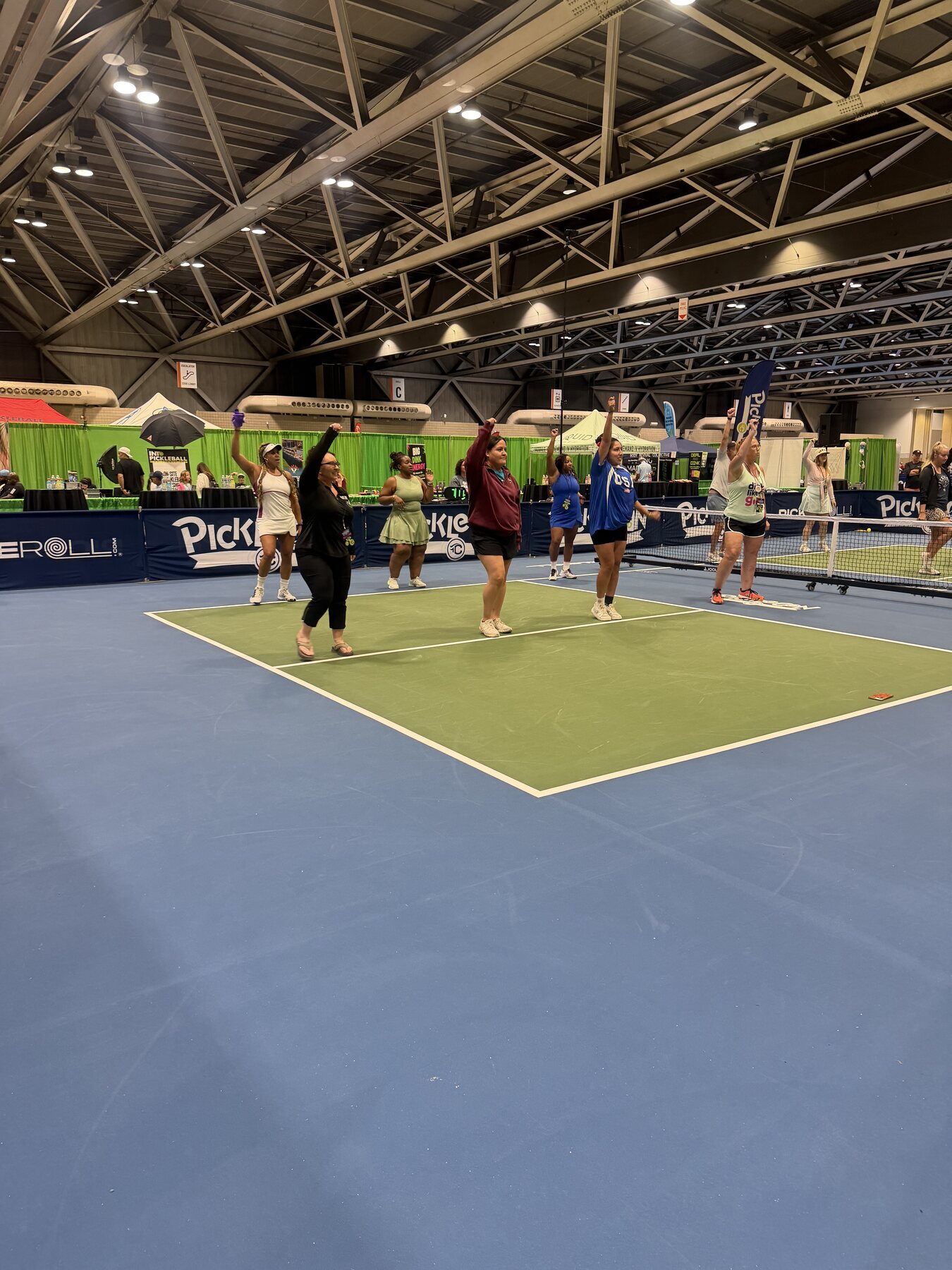 Participants moving together on a PickleCon pickleball court