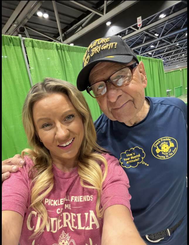 Stephanie Beveridge posing with an attendee at a PickleCon booth