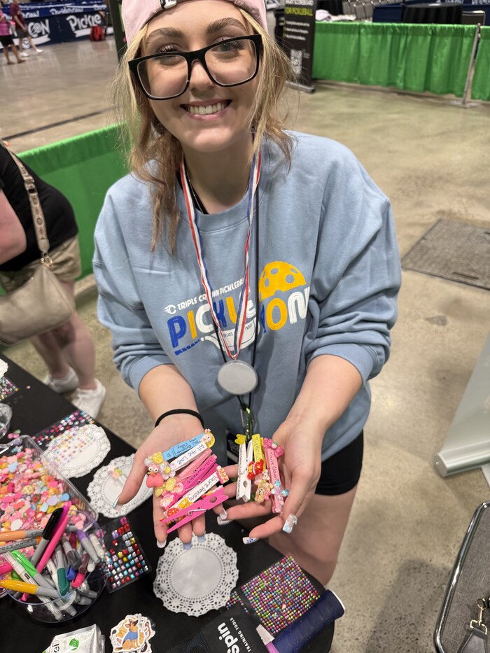 An attendee proudly showing off the Positive Pickle Pins she made